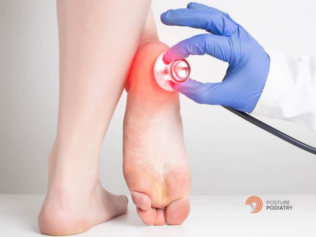 Image displaying two feet with a stethoscope on one heel highlighting inflammation due to plantar fasciitis
